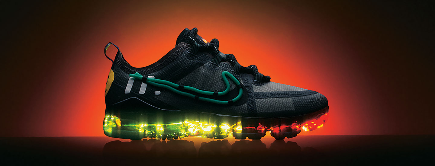 Black Nike sneaker with light-up rainbow bottom