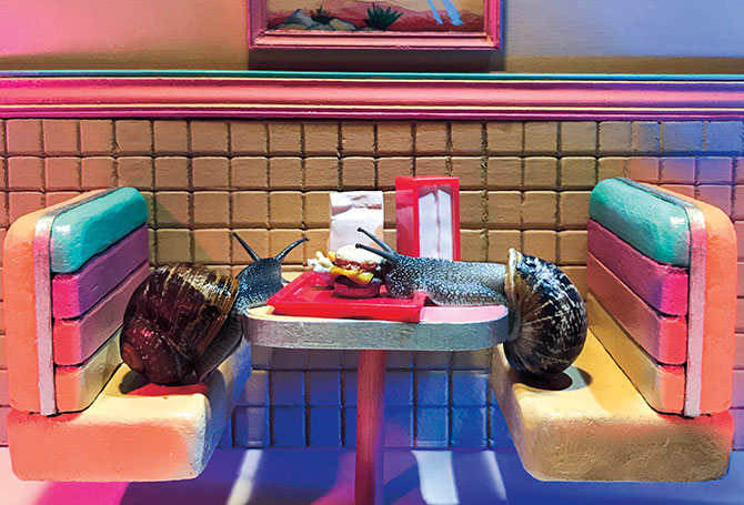 Two snails eating at a restaurant