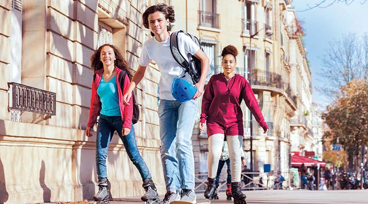 Kids rollerblading and skateboarding